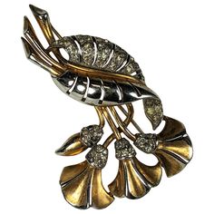 Marcel Boucher Early Lily Brooch from the 1930's. Stylized lily spray in rhodium with gold plating and pave crystal accents. Gold plating is worn on high areas of brooch and gives it a 2 toned look now. 1930's USA. 3" x 2". Brooch Art, Gold Plating, Valentino Garavani, Givenchy, Gold Plate, Lily, Art Deco, Plating, Gold