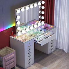 a vanity with lights and drawers in a room next to a red curtained window