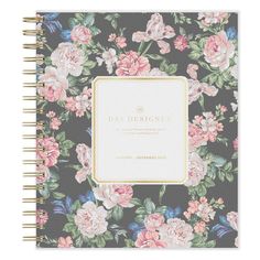 the daily planner with floral print and gold trim is shown on a black background, it has