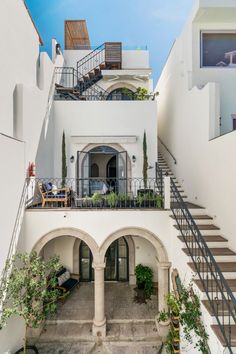 an outdoor courtyard with stairs leading up to the second floor