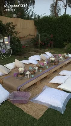 a picnic table with pillows and candles on it