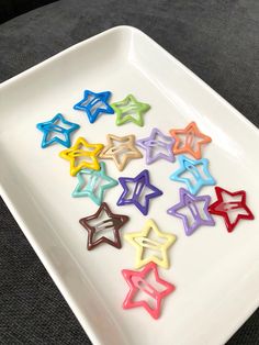 colorful star shaped cookies on a white plate