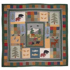 a quilt with animals and trees on it