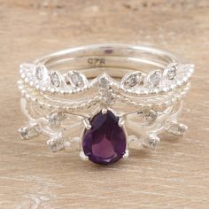 Throughout history, crowns have been a symbol of divine power and authority. That royal and glamorous aura is now present in these sterling silver stacking rings designed by Shivani Choudhary in India. Three pieces embellished with cubic zirconia stones and leafy details come together in a stunning accessory, with a faceted amethyst stone as the centerpiece. Luxury Cubic Zirconia Amethyst Ring With Prong Setting, Power And Authority, Divine Power, Om Pendant, Amethyst Set, Lion Pendant, Sterling Silver Stacking Rings, Silver Stacking Rings, Amethyst Color