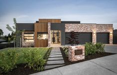 a modern house with brick and wood accents