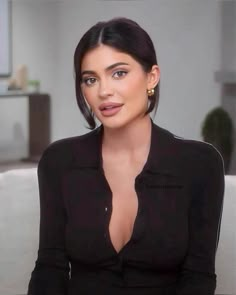 an image of a woman sitting on a couch in front of a tv screen and looking at the camera