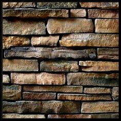 a brick wall that has been made out of various types of stones and is brown