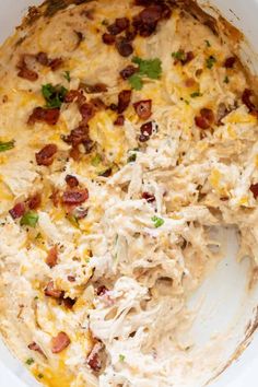 a casserole dish with chicken, bacon and cheese