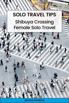 an aerial view of people walking across a crosswalk in the middle of a city