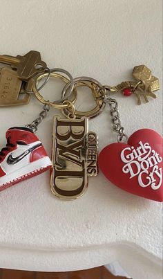 a pair of sneakers and keychains are sitting on a table