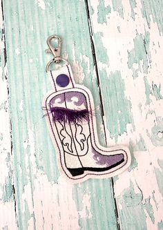 Cowboy Boot Keychain with Fringe, Feunge Boot Key chain, Cowboy Chic Zipper Pull, Boot Bag Tag, Cowboy Key Fob --- 70 Colors These Cowboy Boot keychains are a cute accessory for any fan of Cowboy Chic.  These are perfect for keys, bag tags or zipper pulls.  Choose your vinyl color and thread color from the drop down box below, these are shown with purple thread on white sparkle vinyl.  This will come on a swivel clasp.  This measures 2" wide and 3.5" tall, including the split ring.  It's made fr Cowboy Boot Keychain, Boot Keychain, Cowboy Chic, Cowboy Boot, Bag Tag, Boot Bag, Zipper Pulls, Split Ring, Vinyl Colors