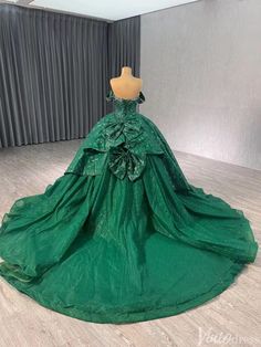 a green ball gown on display in a room