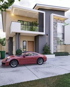 a red sports car parked in front of a modern house with balconies on the second floor