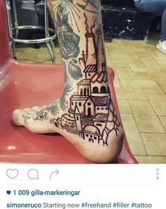 a person's leg with tattoos on it