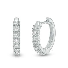 A choice that never disappoints, these sparkling diamond huggie hoop earrings are a jewelry box staple you’ll rely on. Crafted in cool 14K white gold, each huggie earring features a center stripe of seven shimmering diamonds. Radiant with 1/4 ct. t.w. of diamonds and a bright polished shine, these hoops secure with hinged backs. Zales Zales, Huggie Earring, Jewelry Tattoo, Round Moissanite, White Gold Earrings, Huggie Hoop Earrings, Sparkle Diamonds, Vintage Diamond, Diamond Heart