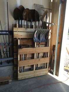 several pairs of shoes are stacked on top of wooden pallets in front of a garage door