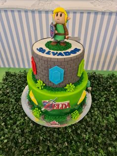 a birthday cake made to look like the legend of zelda character on top of a tower