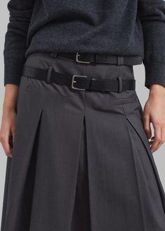 Color: Grey Lightweight woven fabric Relaxed fit Midi length Tennis pleats throughout Front illusion welt pockets Double belt loops Concealed side seam zip closure Partially lined 60% Polyester 25% Rayon 15% Wool Dry Clean By The Frankie Shop. Imported Double Belt, Full Maxi Skirt, The Frankie Shop, Frankie Shop, Pleated Midi Skirt, Gray Skirt, Welt Pockets, Midi Length, Woven Fabric