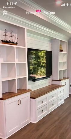 a large entertainment center with built - in bookshelves and white painted cabinets is shown