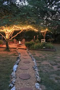 a path made out of stones leads to a fire pit