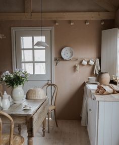 the kitchen is clean and ready to be used for cooking or baking, with dishes on the table