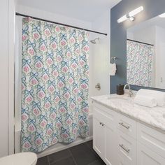 a bathroom with blue walls and white cabinets