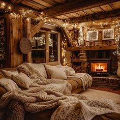 a cozy living room with a fireplace and christmas lights