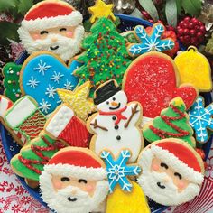 decorated christmas cookies in the shape of santa claus, snowman and other holiday treats