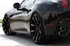 the rear end of a black sports car