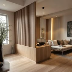 a living room filled with furniture next to a tall wooden paneled wall in front of a window