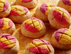 some cookies with pink and yellow designs on them