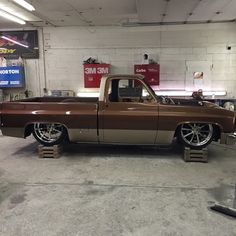 a brown and white truck parked in a garage