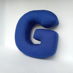 a blue pillow shaped like the letter g