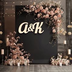 a black backdrop with pink and white flowers on it that says c & k in gold lettering