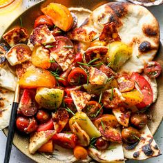 a plate full of grilled vegetables and pita bread