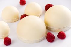 small desserts with raspberries on a white plate