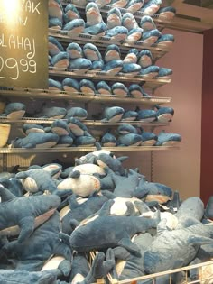 there are many blue stuffed animals in the store