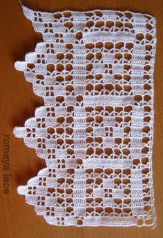 white crocheted doily sitting on top of a wooden table