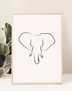 an elephant's head is drawn in black ink on a white background next to a potted plant