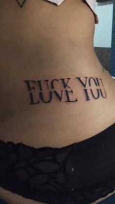 a woman's stomach with the words i love you tattooed on her lower back