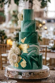 a three tiered green and white wedding cake