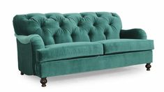 a green velvet couch with wooden legs and buttons on the arm, against a white background