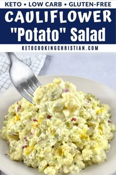 a white plate topped with potato salad next to a fork