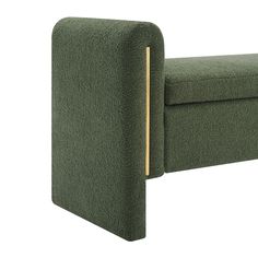 an upholstered green couch with wooden legs