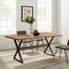 a dining room table with chairs and a vase