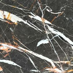 black marble with orange and white streaks on it