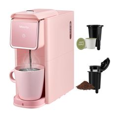 a pink coffee maker with two cups next to it and one cup filled with liquid