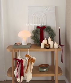 a wooden table topped with candles and stockings