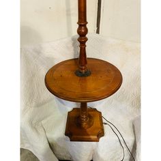 an old wooden table with a lamp on top