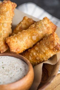 some fried food is on a plate with dipping sauce